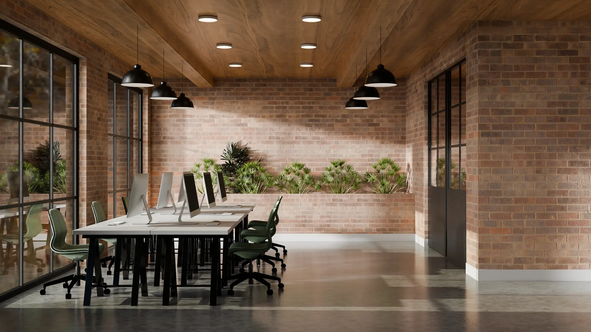 Modern open-plan office with brick walls and standing desks